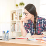 Female student at computer studying for an LPN/LVN entrance exam