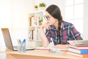 Female student at computer studying for an LPN/LVN entrance exam